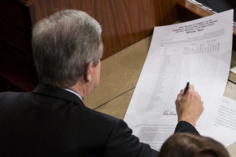 A man signs a piece of paper
