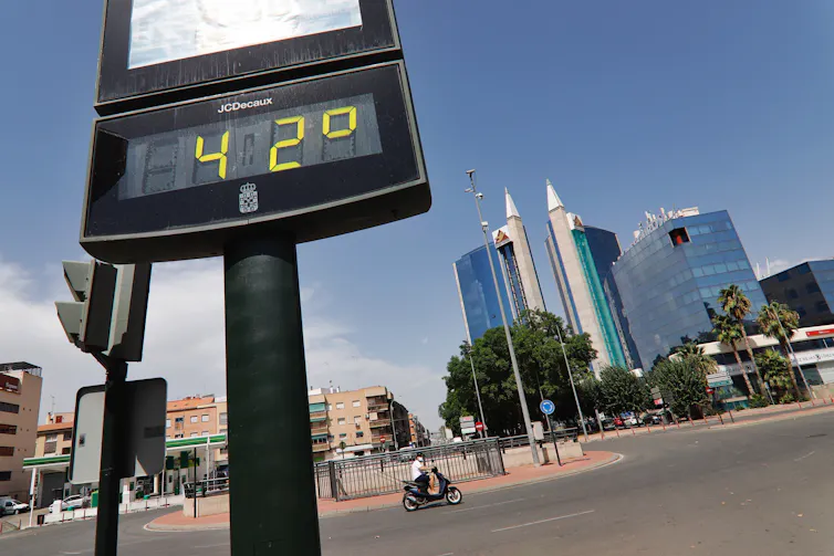A roadside thermometer shows 42°C