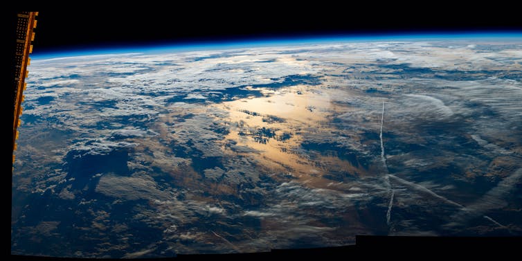 The view of sunrise over Earth as seen from the International Space Station