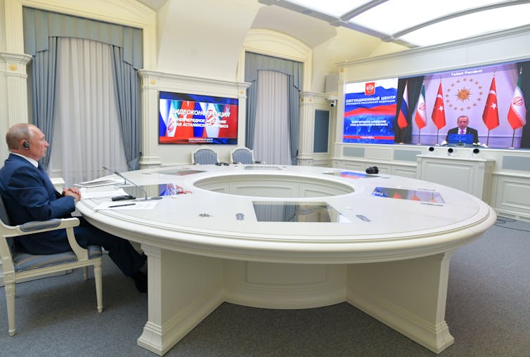 Russian president Vladimir Putin in a video conference with Turkish president Recep Tayyip Erdogan and, off screen, Iran's president Hassan Rouhani.