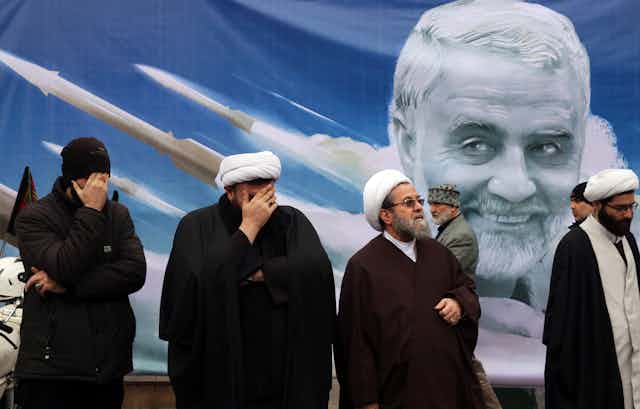 Four senior Iranian clerics in front of a poster depicting general Qasem Soleimani was was assassinated in Iraq in 2018.