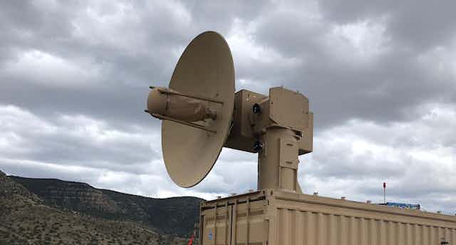 A dish antenna on a movable mount in a desert