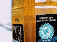 A bottle of iced tea with the Rainforest Alliance logo.