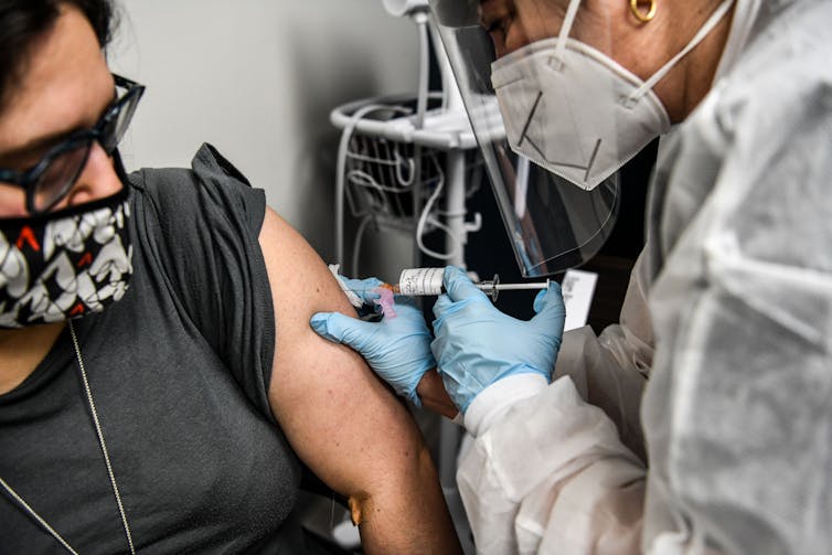 A woman receiving a vaccination.