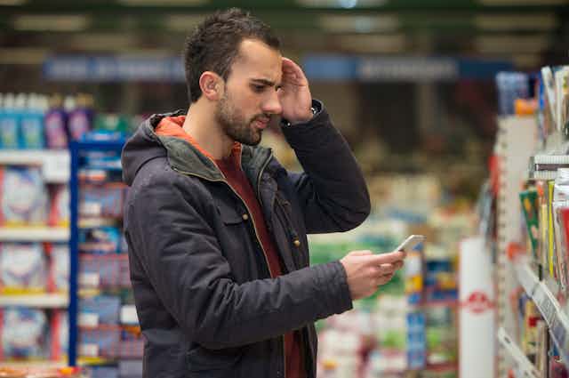 A man looking confused at the grocery store.