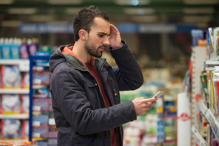 A man looking confused at the grocery store.