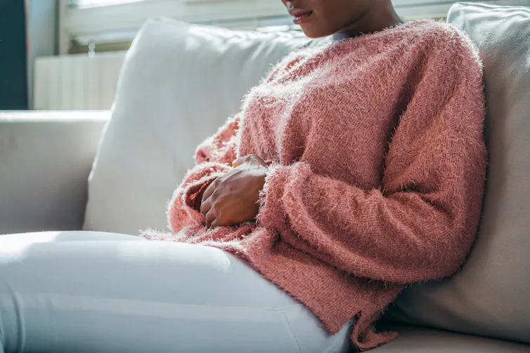Person clutching their stomach