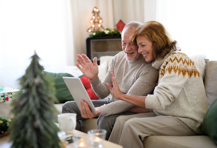 An older couple celebrating Christmas over Zoom with family