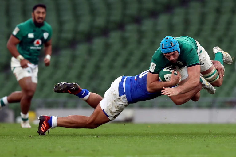 A rugby player tackled mid-air.