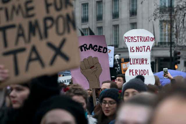 Protest sign reading 'menstruation is not a luxury period'