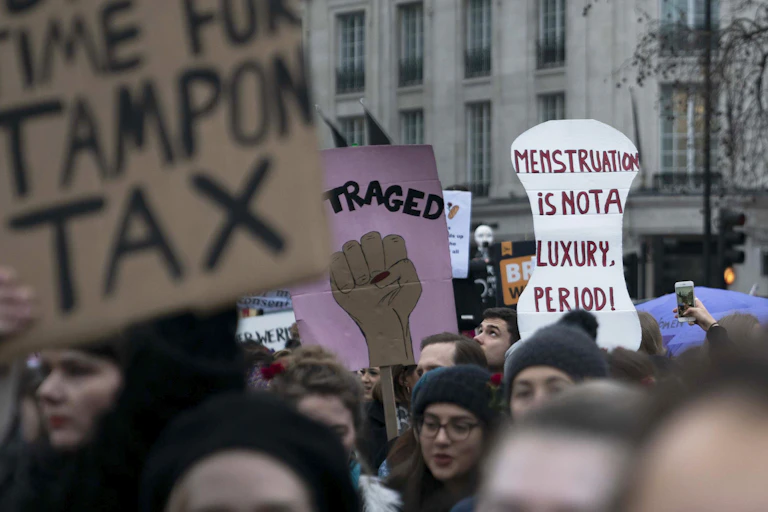 Protest sign reading 'menstruation is not a luxury period'