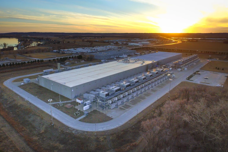 Aerial view of a massive warehouse-like structure with massive HVAC units along one side