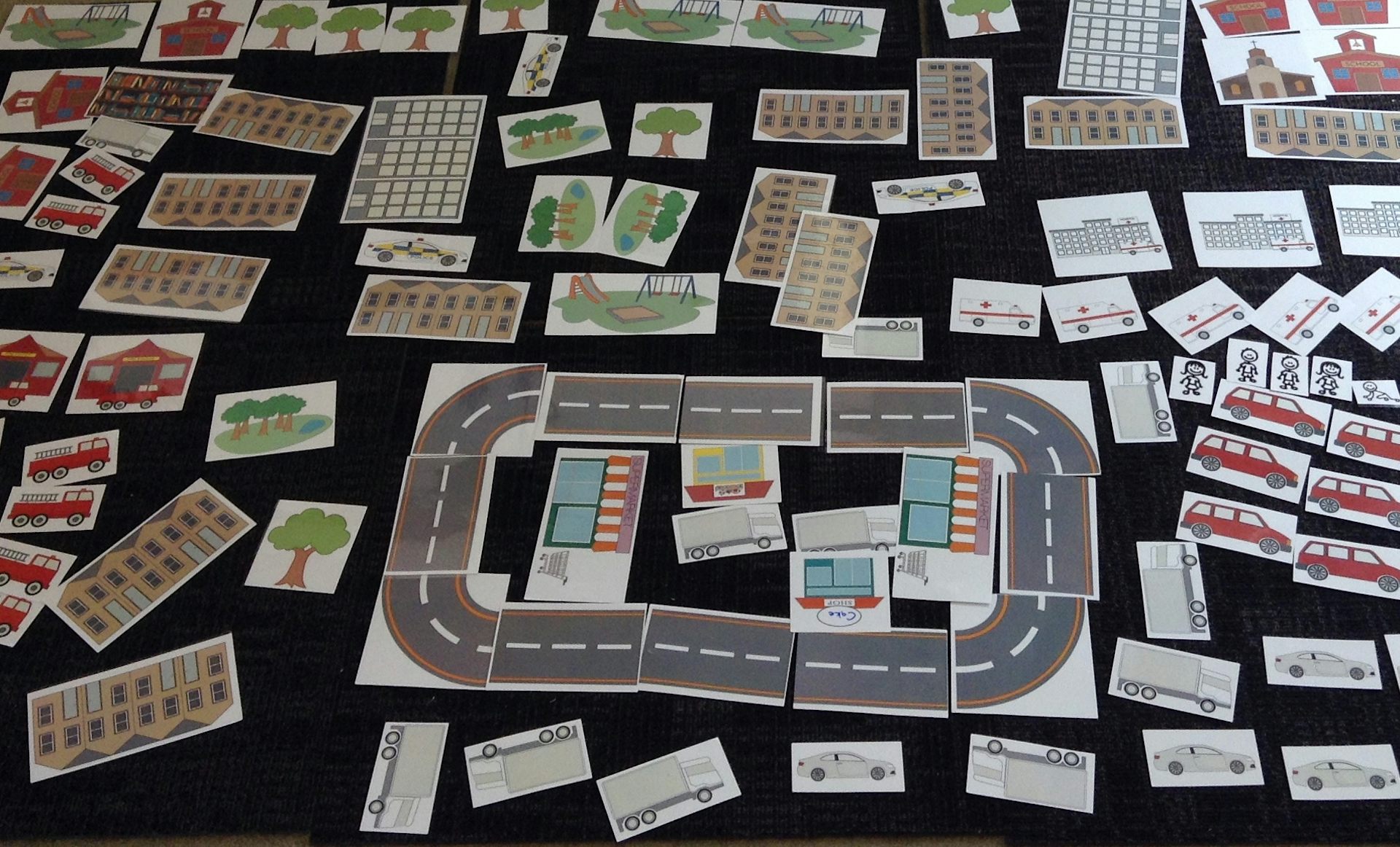 Cut out pictures of cars, buildings and roads