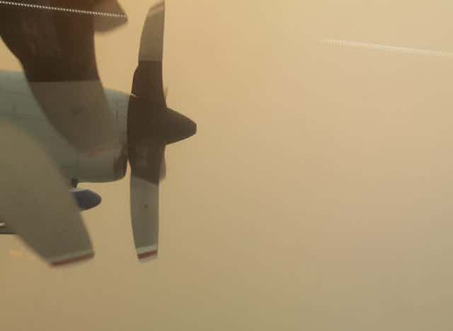 The view from the airplane window while flying through smoke.