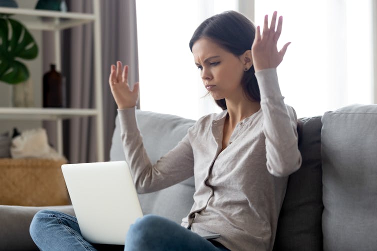 Woman on sofa angry with laptop