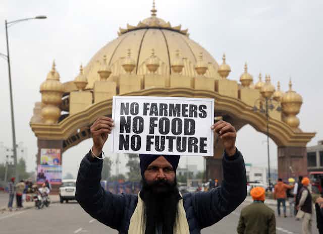 A Sikh protester holds up a sign as part of the farmers' strike in India.