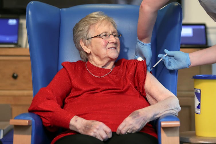 An elderly woman being vaccinated with the Pfizer/BioNTech vaccine.