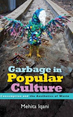 A book cover for 'Garbage in Popular Culture' that features a photograph of a sculpture of a bird, made from colourful plastic waste, taken in an urban setting.