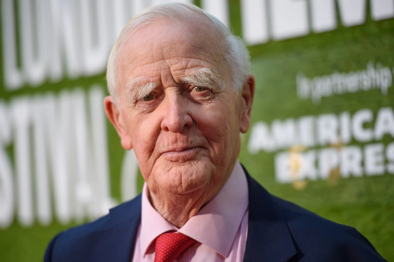 Elderly man in a suit with a red tie.