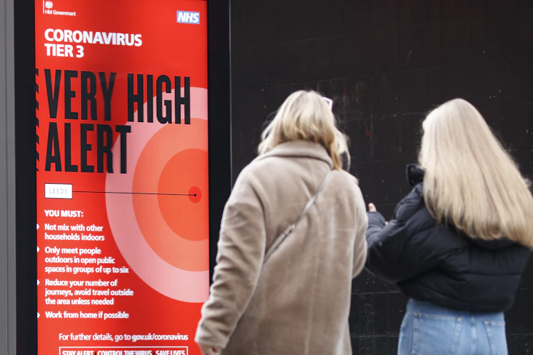 A red sign warning people that they are in a very high alert level area during the coronavirus pandemic.