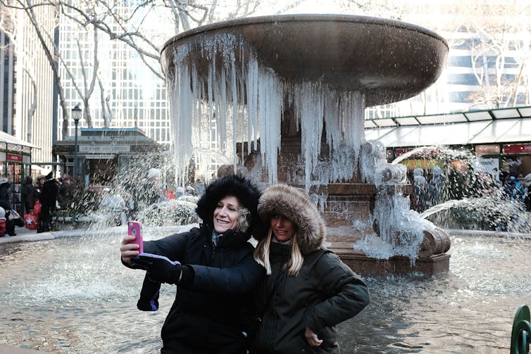 Two women outside during the winter.