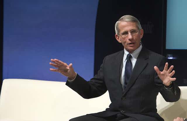 Fauci seats speaking onstage