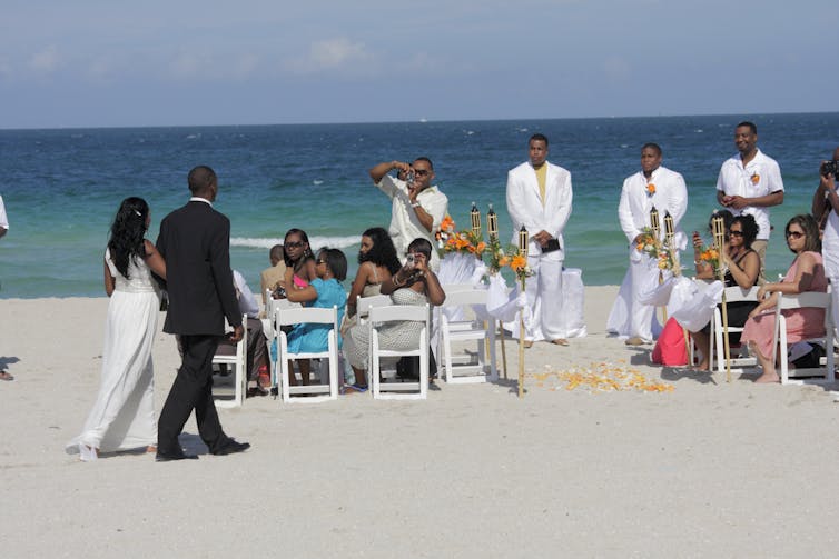 A Black couple gets married on the beach in Miami, Fla.