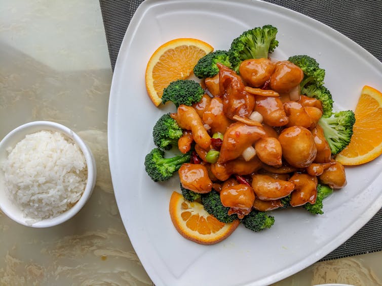 Fried food covered in an orange sauce.