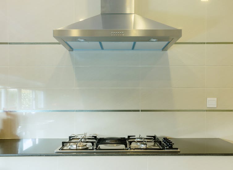 A range hood above a gas stovetop