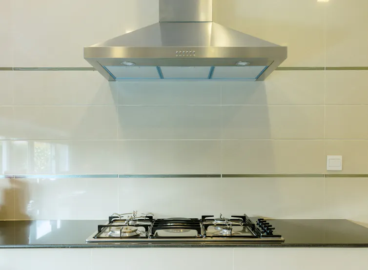 A range hood above a gas stovetop