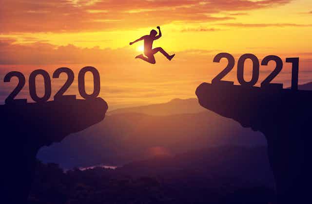 Person jumps from symbolic '2020' cliff to '2021' cliff.