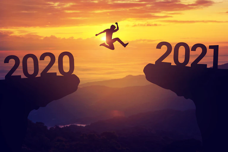 Person jumps from symbolic '2020' cliff to '2021' cliff.