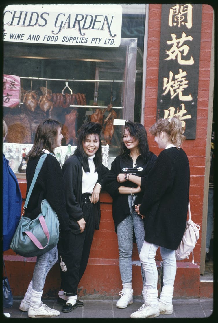 A group of young Asian and white women talking.