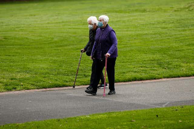 An elderly couple, walking