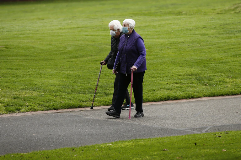 An elderly couple, walking