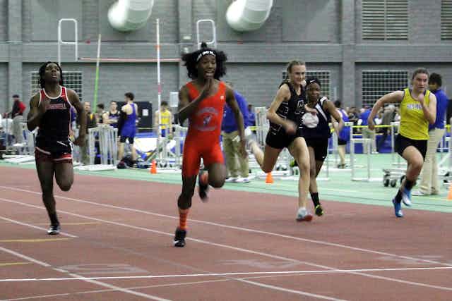High school athletes run during a track race