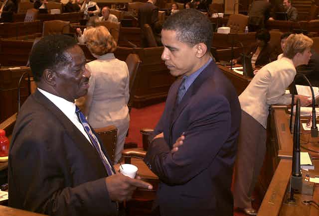 In a photo from 2004, Barack Obama speaks to a fellow Illinois legislator in the state Senate chamber.