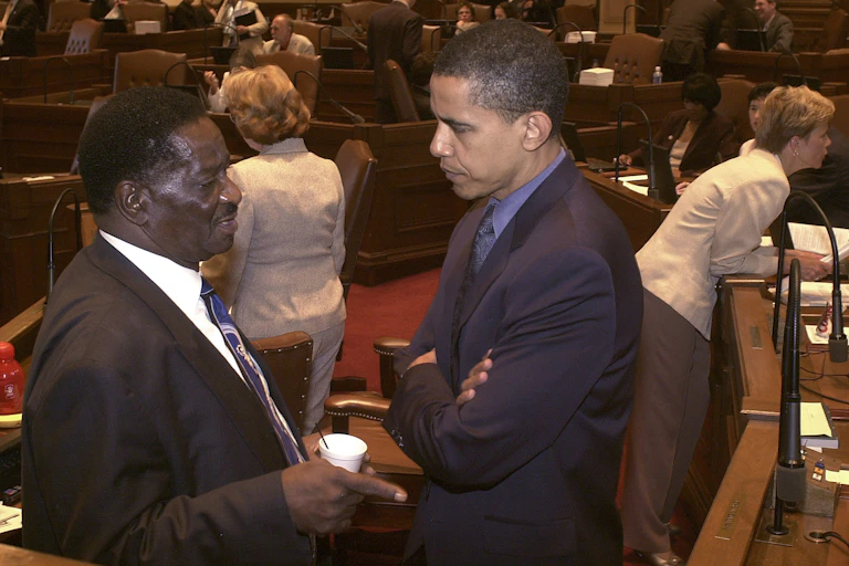 In a photo from 2004, Barack Obama speaks to a fellow Illinois legislator in the state Senate chamber.