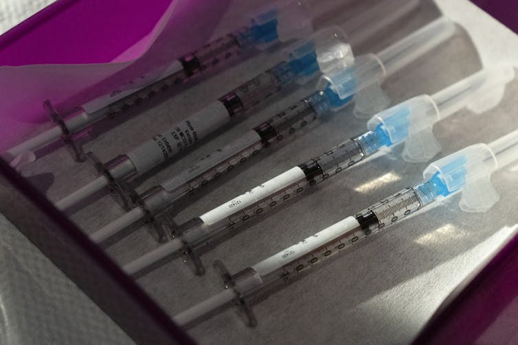 Five vaccines laid down in a row.