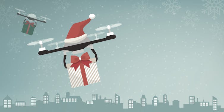 Illustration of two drones carrying gifts and decorated with Santa hats.