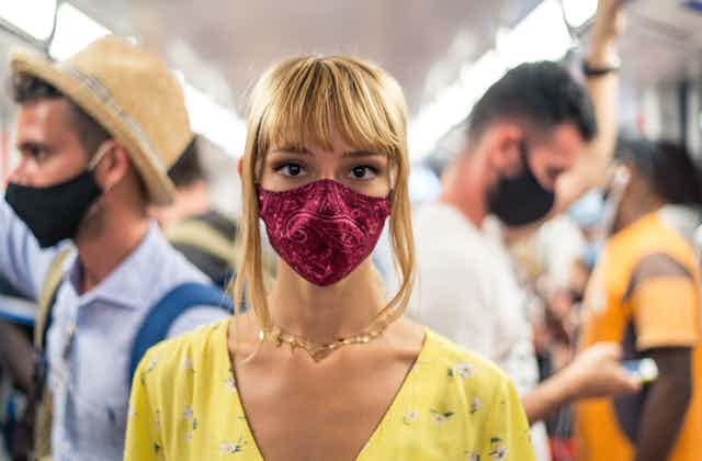 Woman wearing cloth mask on public transport