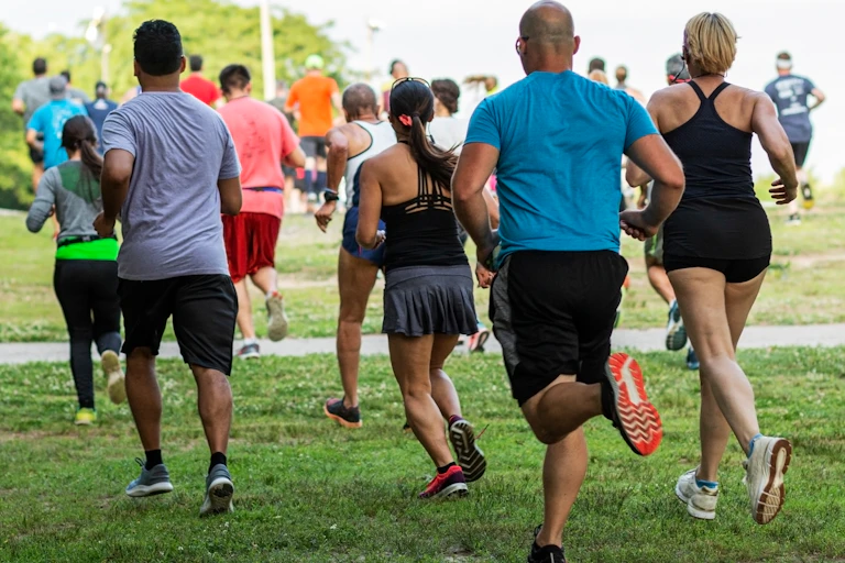 A group of people running in a park.