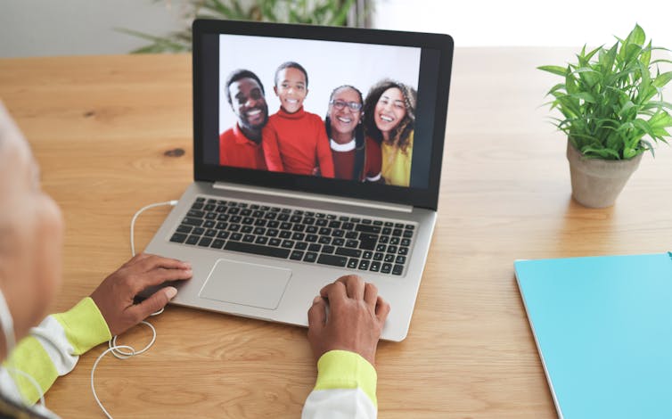 An older woman talking to her family on a video call