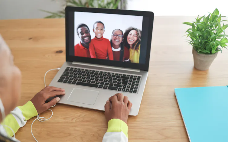 An older woman talking to her family on a video call