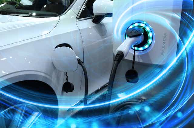 An electric car charging with swirling blue energy