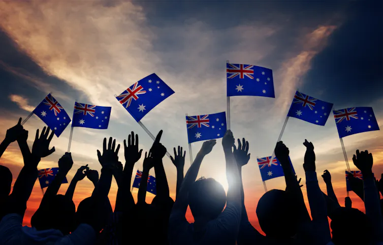 Crowd waving Australia flag