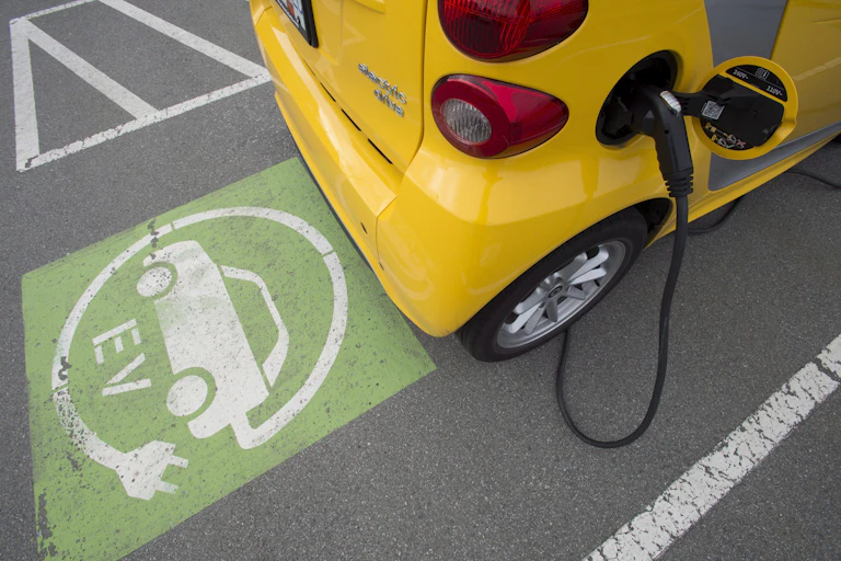 A yellow electric vehicle being charged