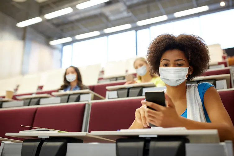 Students earing masks in a lecture theatre at university