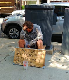 panhandler with sign