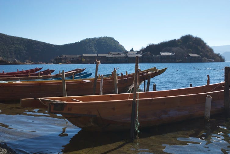 Mosuo boats on scenic Lugu Lake.
